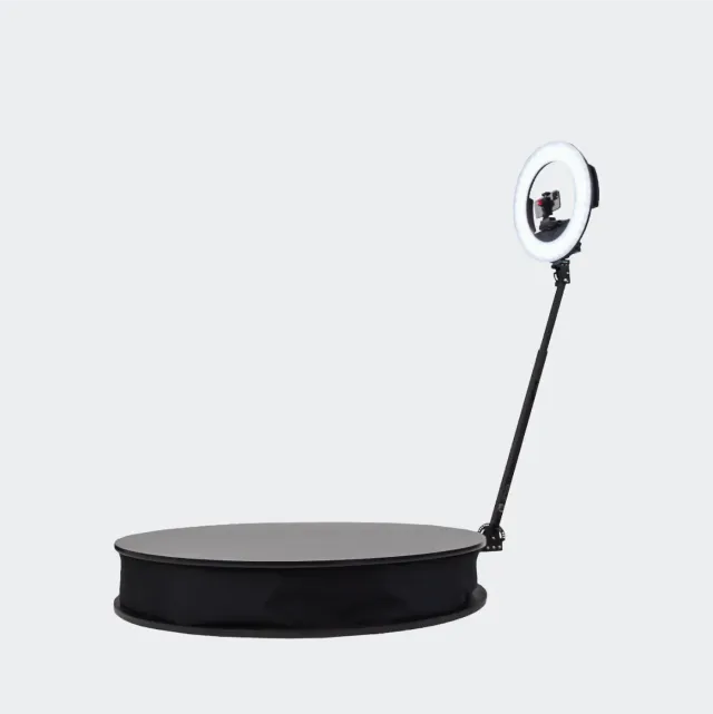 360 photo booth: a low round spin platform with a central camera arm, ready for guests to step on.