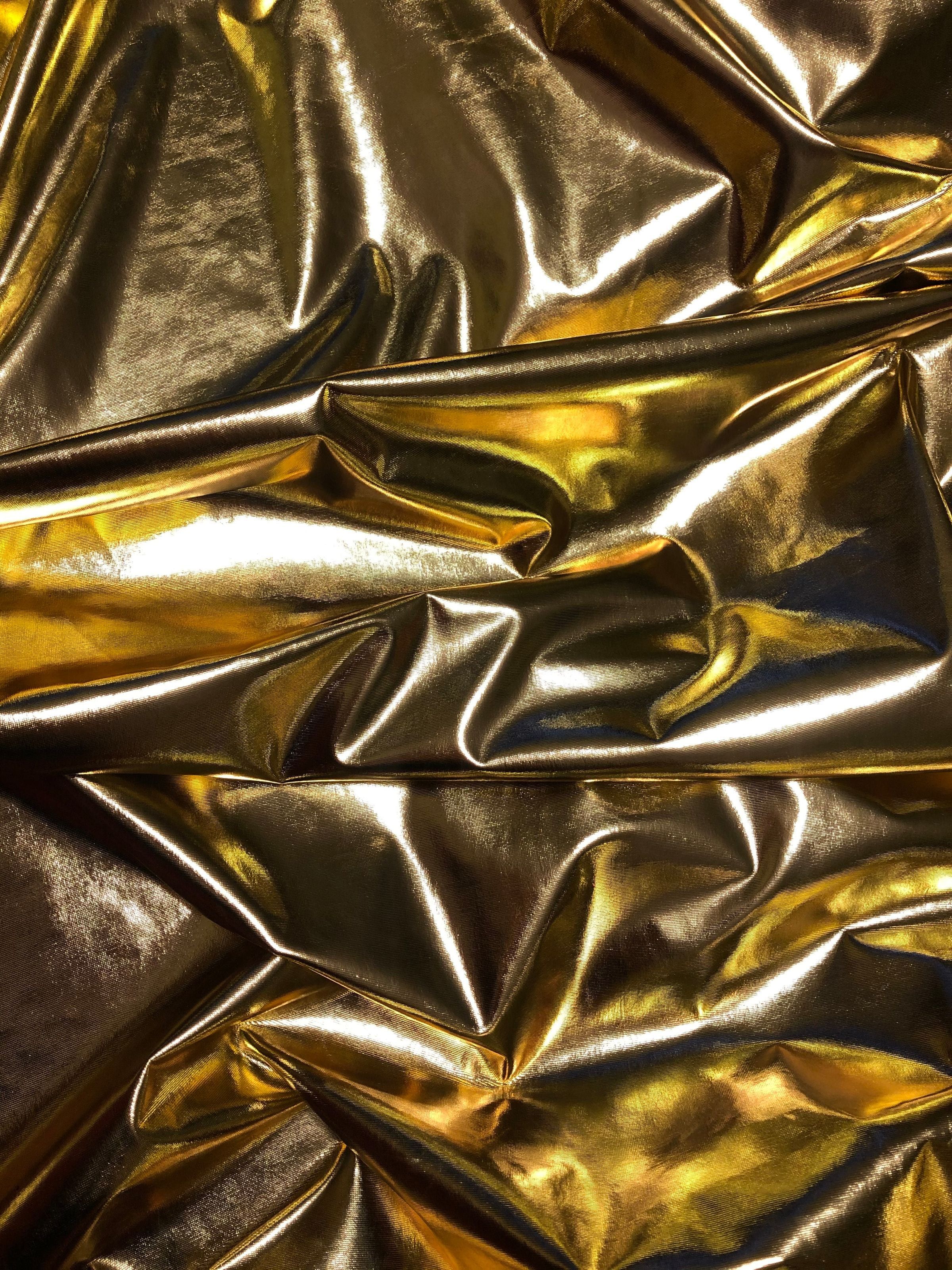 Crinkled gold metallic fabric texture in close-up